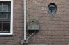 Zijgevel met ronde trappenhuisvensters en een uitgemetselde gootsteen (Elandsstraat 88) (© Walther Schoonenberg)